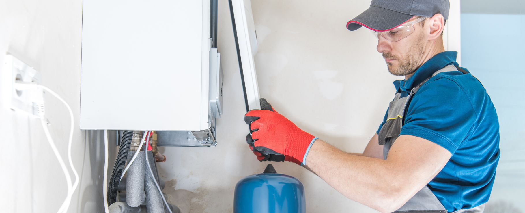 Plumber installing a commercial gas hot water heater with precision and expertise.